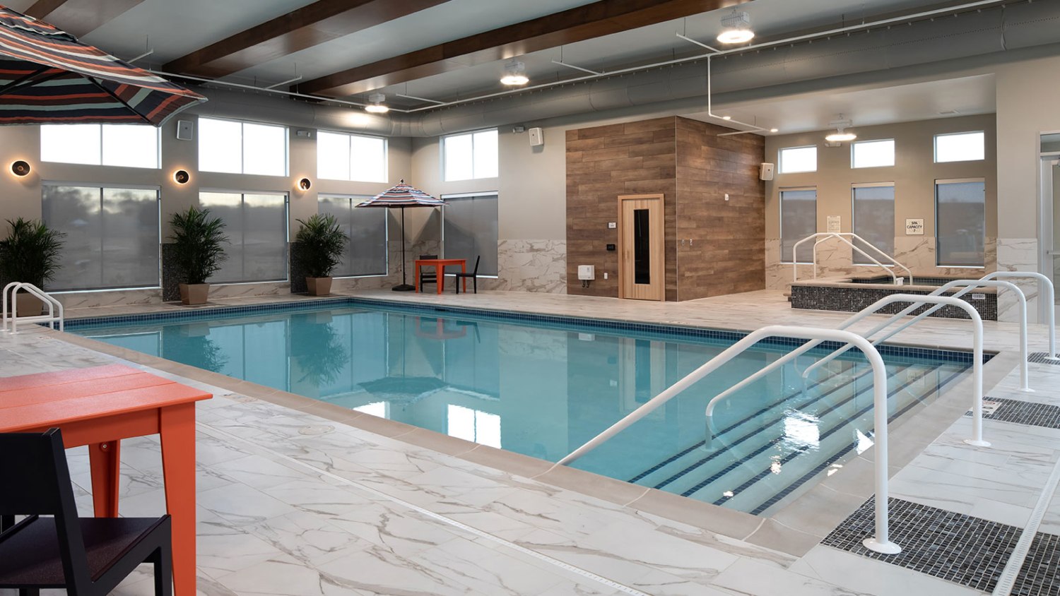 Indoor pool with seating areas, sauna and spa